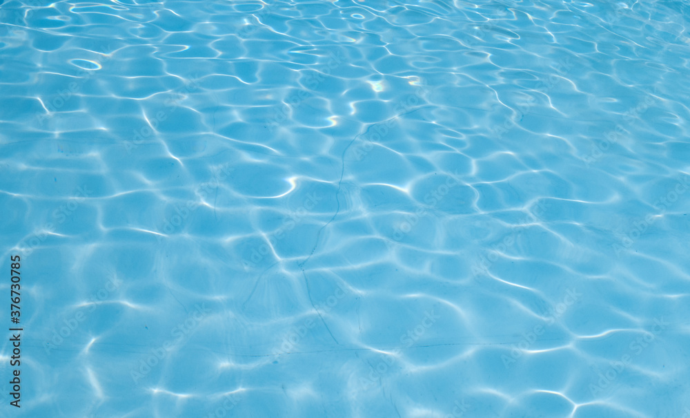 Beautiful ripple wave and blue water surface in swimming pool. Blue water surface background.