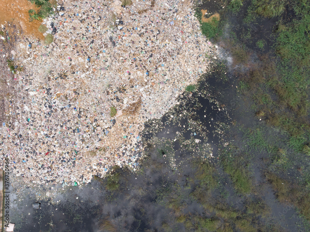 Aerial photo of plastic waste and sewage from the city cause environmental pollution poisoning the air and polluting the water supply Aerial photo of plastic waste and sewage from the city cause environmental pollution poisoning the air and polluting the water supply