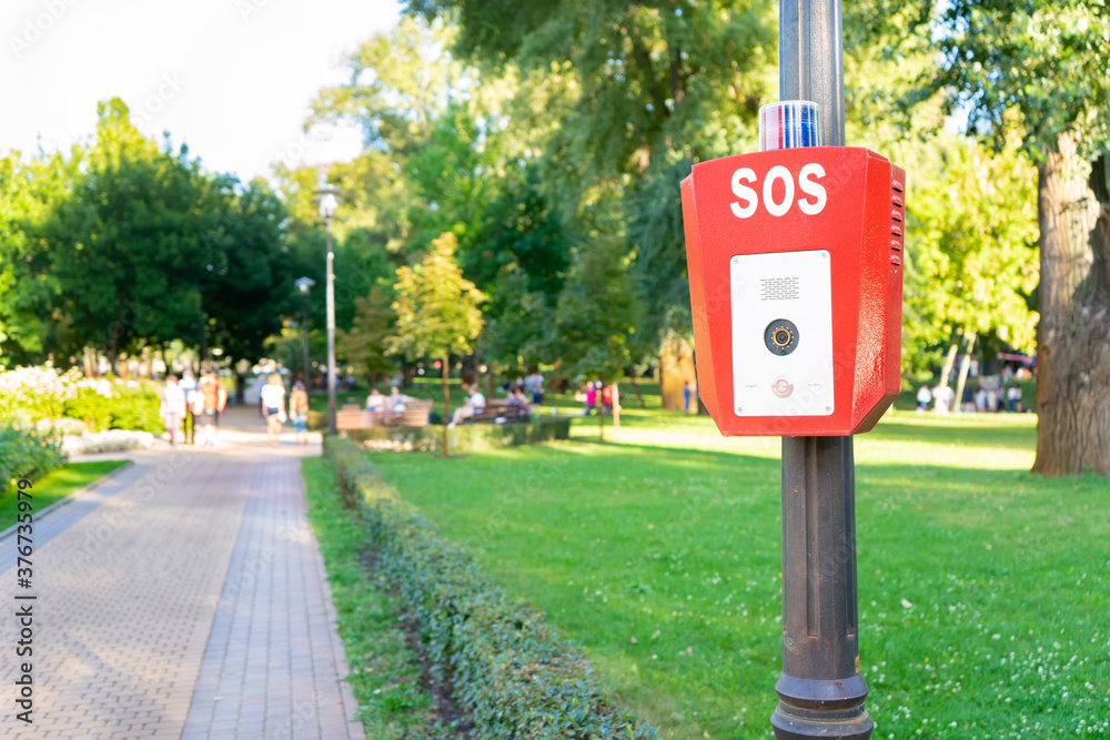 SOS, police, emergency button in the public park. SOS, police, emergency button in the public park.