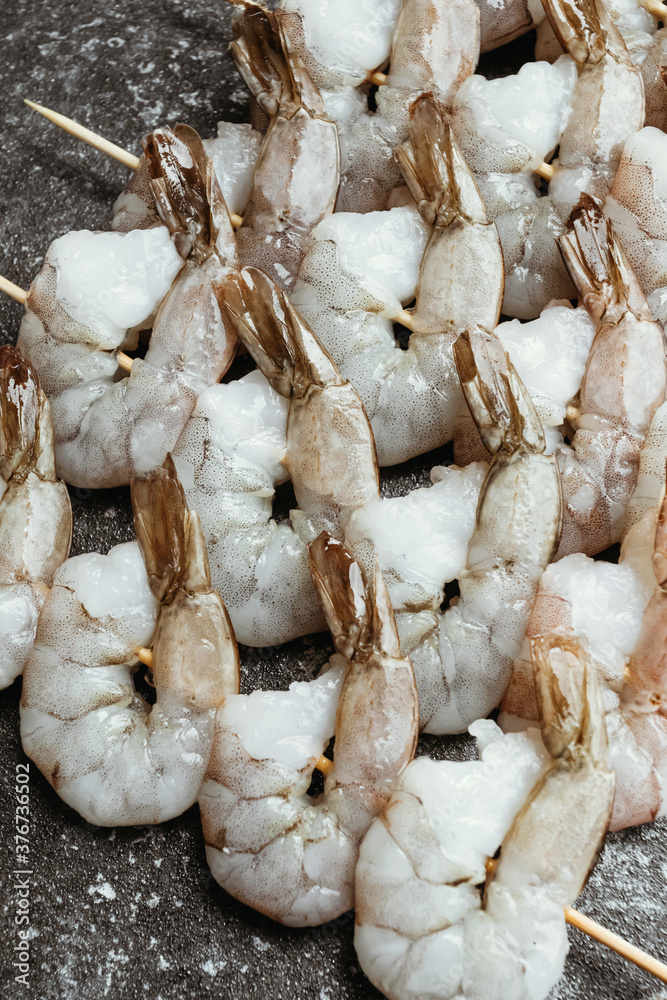 Fresh shrimps with lemon and thyme on skewers. Macro. Fresh shrimps with lemon and thyme on skewers. Macro.