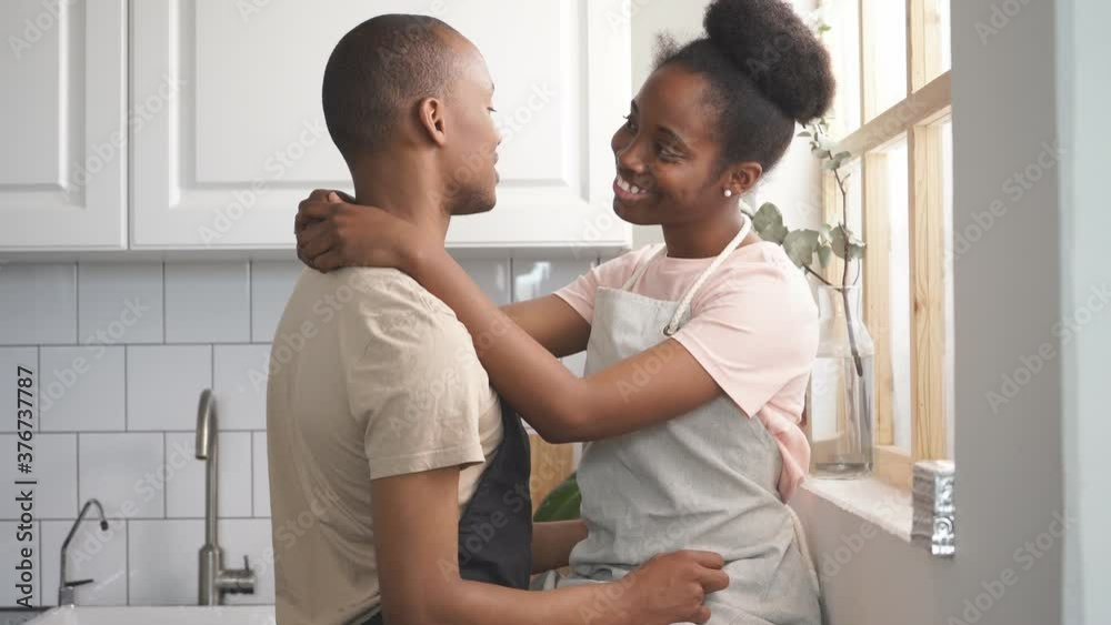 Beautiful young couple have rest in kitchen, enjoy cooking together, free time at home, in love. Beautiful young couple have rest in kitchen, enjoy cooking together, free time at home, in love.
