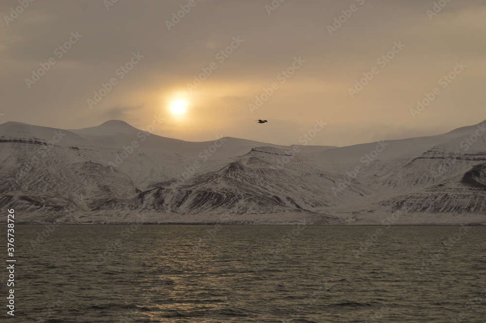 Winter sunset over the ice fjords of the Archipelago of Svalbard (Spitsbergen) in Norway Winter sunset over the ice fjords of the Archipelago of Svalbard (Spitsbergen) in Norway
