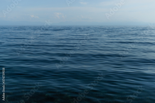 clear calm dark blue water surface of lake baikal, morning ripples © SymbiosisArtmedia