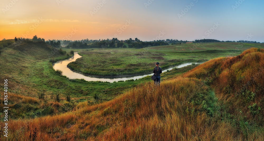 girl looks at the picturesque river. tourist over the river. picturesque autumn morning