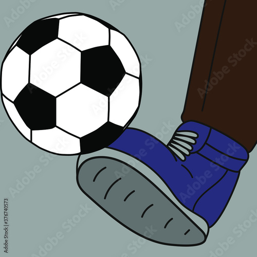 A foot in a boot kicks a football 