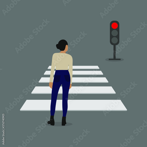 Female character stands in front of a pedestrian crossing and a traffic light with a red signal