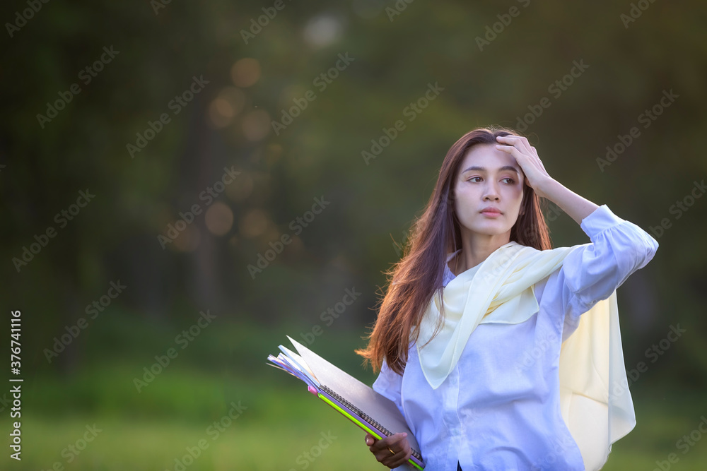 Portrait of focused woman is focused on jotting down important information of the person in preparation for the entrance exam. Getting ready for a professional start. Portrait of focused woman is focused on jotting down important information of the person in preparation for the entrance exam. Getting ready for a professional start.