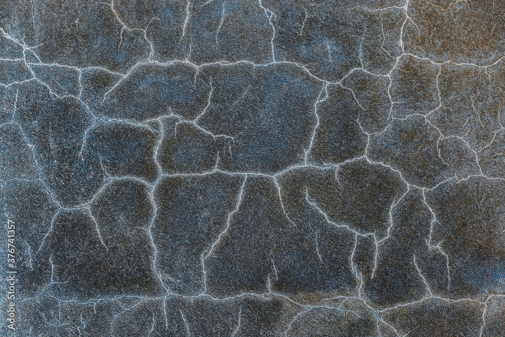 Abstract blue background. Cracks. The texture of the old surface. Cracks in the old plaster. Old texture. Grunge texture. Blue grunge background.
