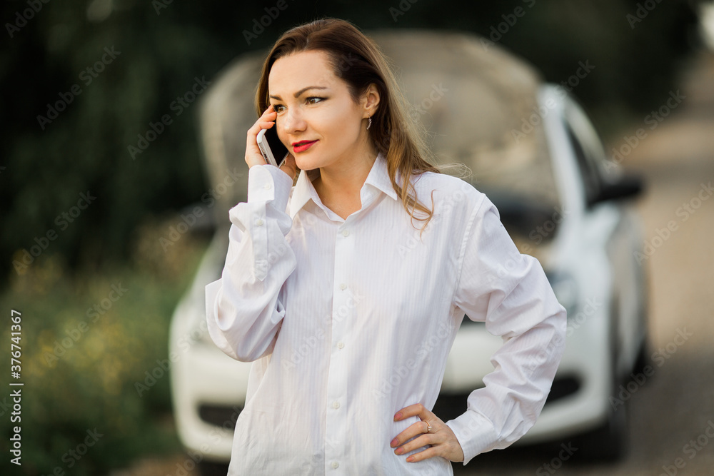 beautiful young woman with mobile phone near car beautiful young woman with mobile phone near car