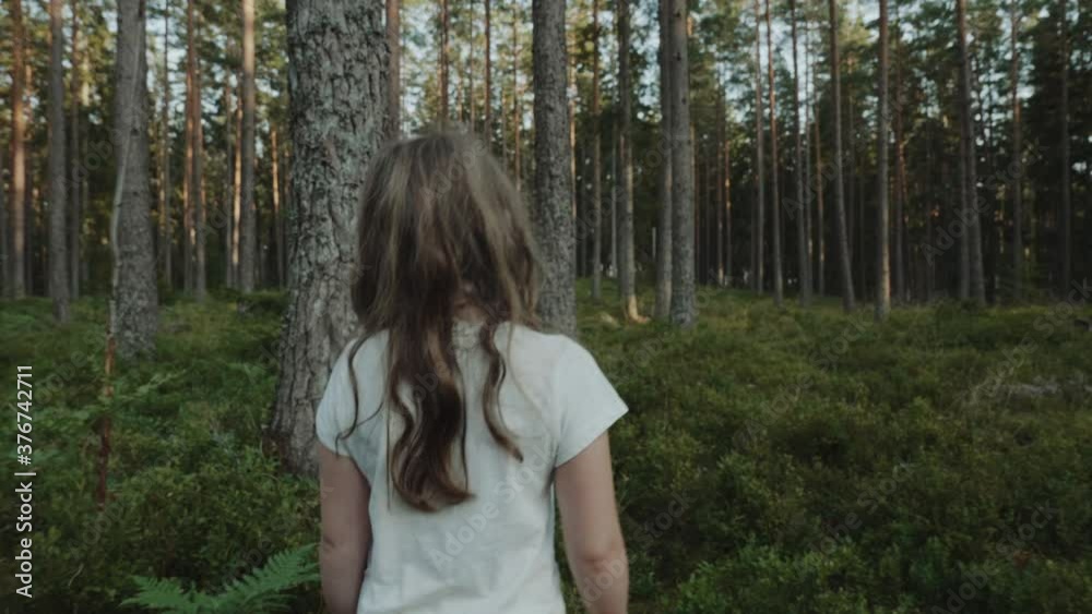 Girl walks in mysterious forest alone Girl walks in mysterious forest alone
