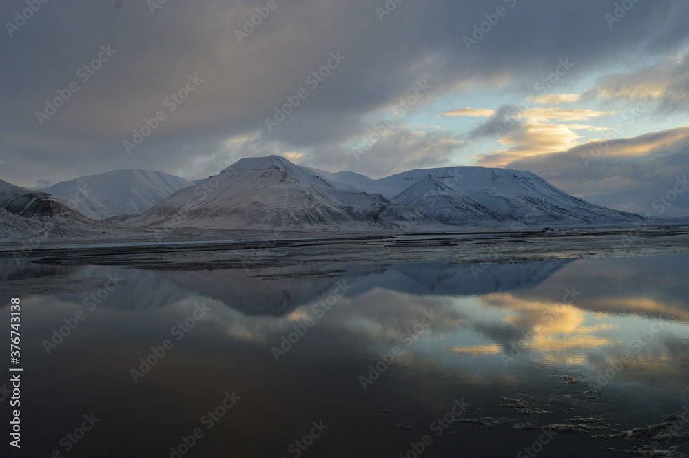 Fototapeta premium Sunset reflections over the frozen Arctic Norwegian Archepelago of Svalbard, Norway