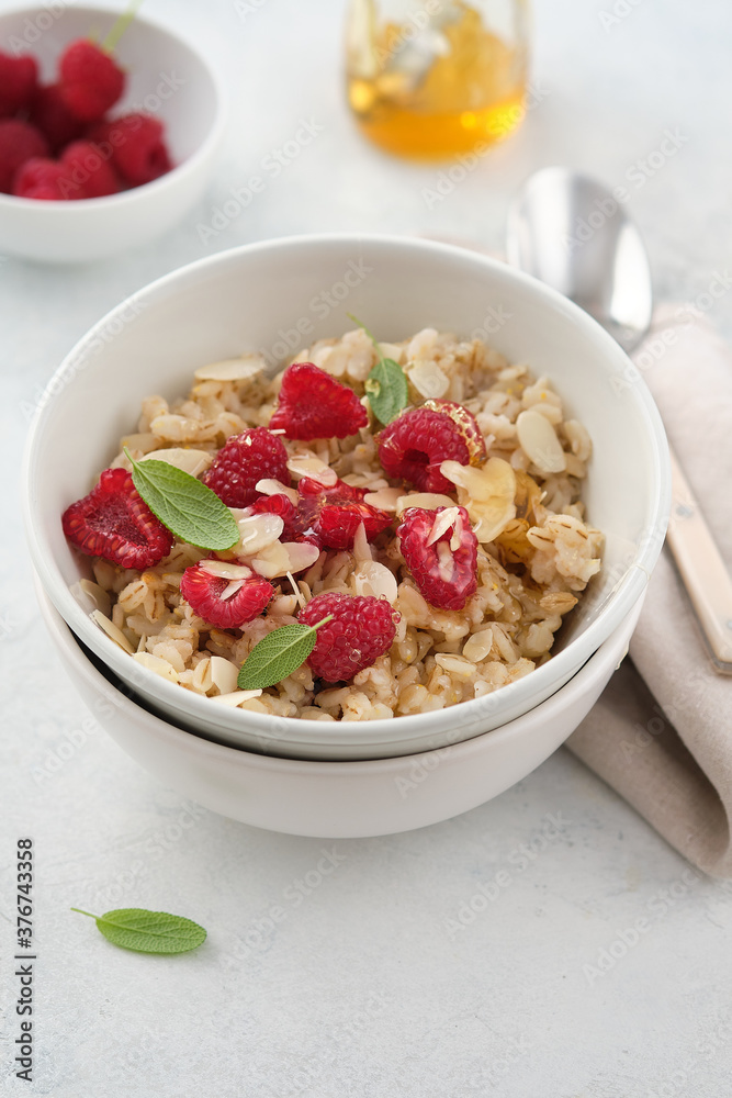 Oatmeal with raspberries, honey and almond petals. Healthy breakfast. Oatmeal with raspberries, honey and almond petals. Healthy breakfast.