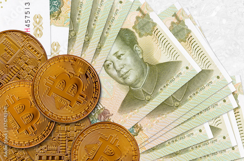 1 Chinese yuan bills and golden bitcoins. Cryptocurrency investment concept. Crypto mining or trading photo