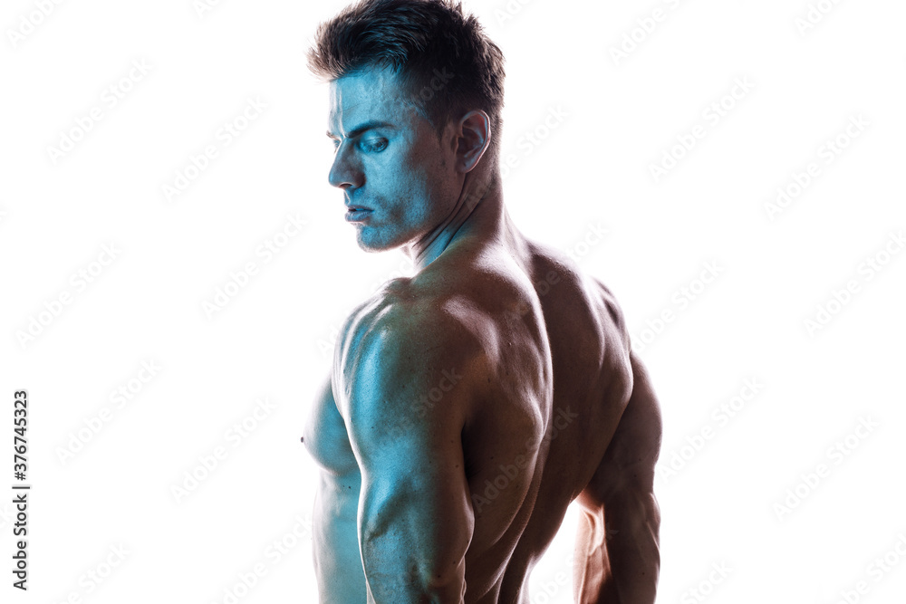 Fototapeta premium Model sports young man on white background. Sporty muscle guy showing his back and big shoulders. Sexy male flexing his muscles. Workout bodybuilding concept.