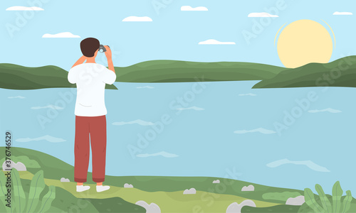 A young man standing on the shore of a lake or river and looking at the horizon with binoculars. Flat vector illustration