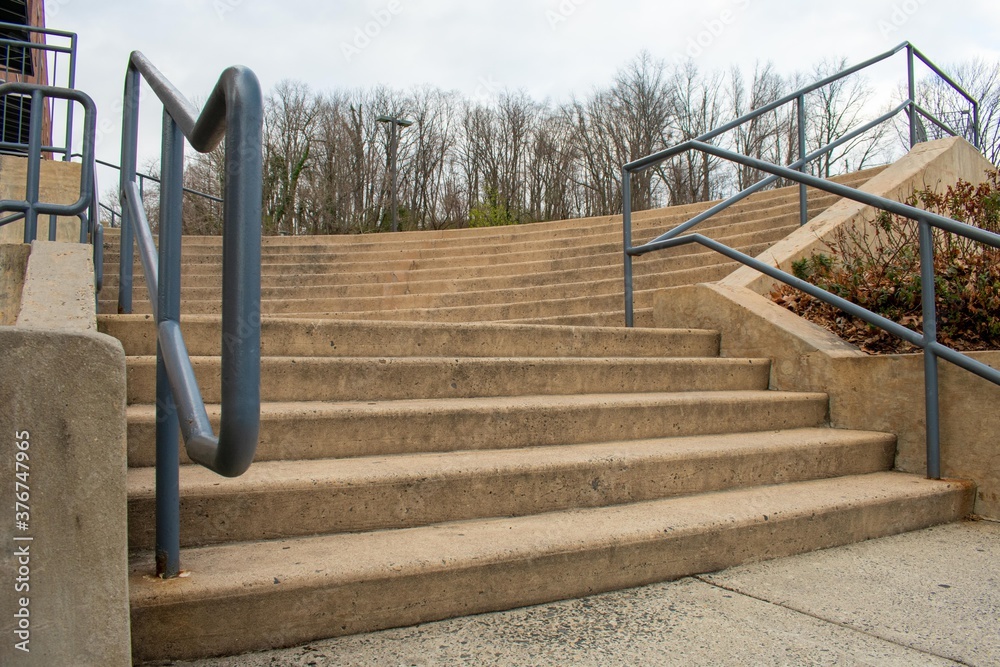 A Set of Concrete Steps With a Green Railing in a Shopping Center in Suburban Pennsylvania A Set of Concrete Steps With a Green Railing in a Shopping Center in Suburban Pennsylvania