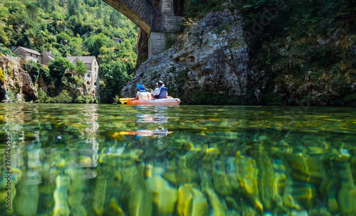 Fotografie, Obraz Couple paddles a kayak on the river Tarn. Gorges du Tarn, France
