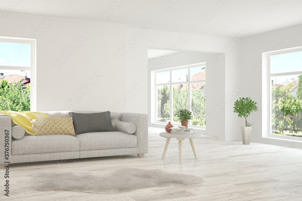 Fototapeta premium White living room with sofa and summer landscape in window. Scandinavian interior design. 3D illustration