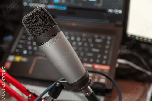 Studio microphone and computer at music studio or podcast