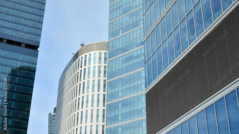Bottom view of glass silhouette of skyscraper. Business building. Skyscraper with glass facade. Modern building in business district. Concepts of economics, financial, future. Bottom view of glass silhouette of skyscraper. Business building. Skyscraper with glass facade. Modern building in business district. Concepts of economics, financial, future.