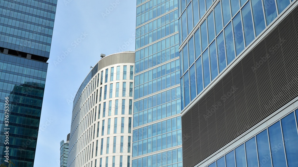 Bottom view of glass silhouette of skyscraper. Business building. Skyscraper with glass facade. Modern building in business district. Concepts of economics, financial, future.   