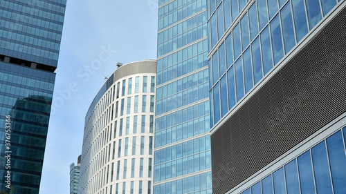 Bottom view of glass silhouette of skyscraper. Business building. Skyscraper with glass facade. Modern building in business district. Concepts of economics, financial, future. 