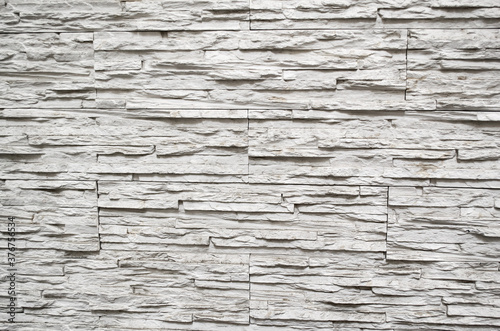 Wall finishing tiles in the form of white and gray aged stone