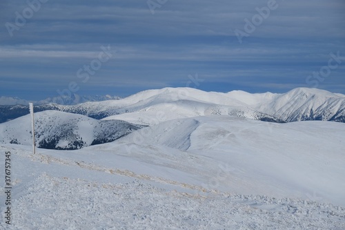 Beautiful winter mountain views during a snowshoe hike along the red ridge trail around Kosarisko Peak in the Low Tatras, Slovakia © Iwona