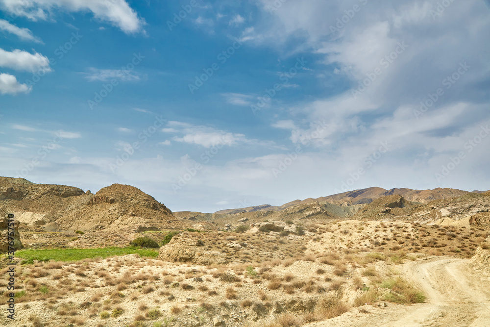 a sandy road in the mountains of Asia. sand surface dried without rain