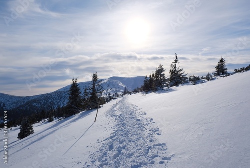 Beautiful winter mountain views at sunset during a snowshoe hike along the red ridge trail around Sedlo pod Skalkou in the Low Tatras, Slovakia - trampled tracks in the snow © Iwona