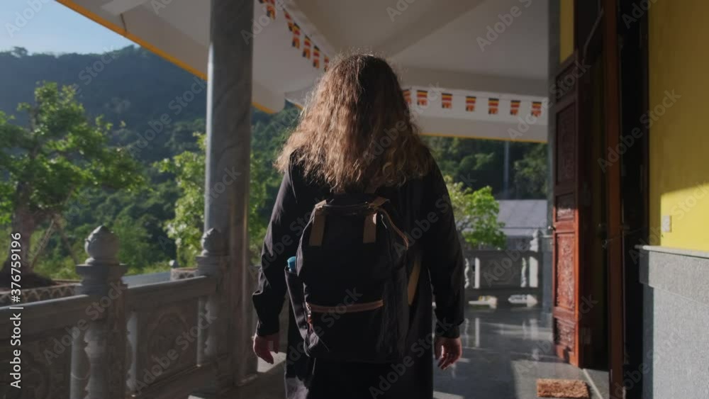 female traveler is walking in Truc Lam Ho Quoc Zen Monastery in Vietnam