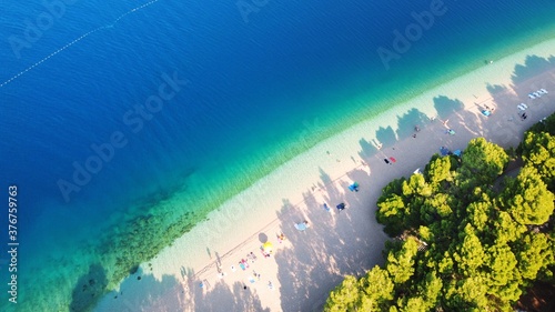 Beautiful Punta Rata beach in Brela, Croatia, aerial view. Adriatic Sea with amazing turquoise clean water and white sand on the beach. 