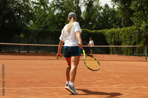 Two people playing tennis on clay court © Atlas