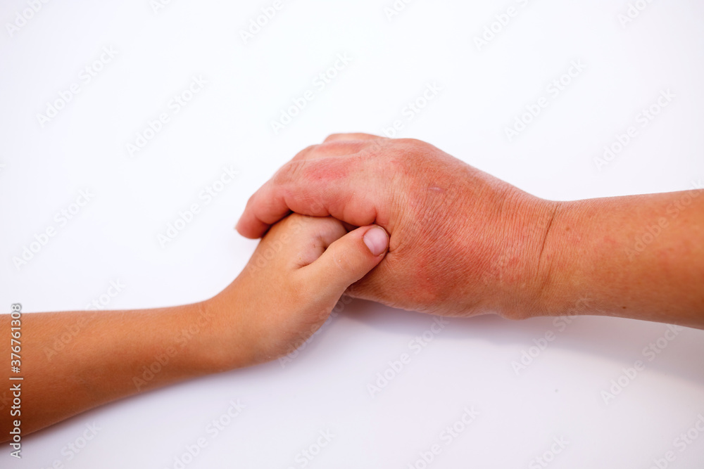 the hand of a laid man hugs the hand of a child on a light background the hand of a laid man hugs the hand of a child on a light background