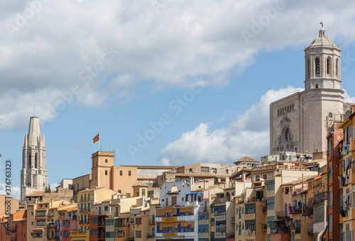 The cathedral and Sant Felix church behind skyline of Girona Town. Catalan independetist flag and houses of the old quarter photo