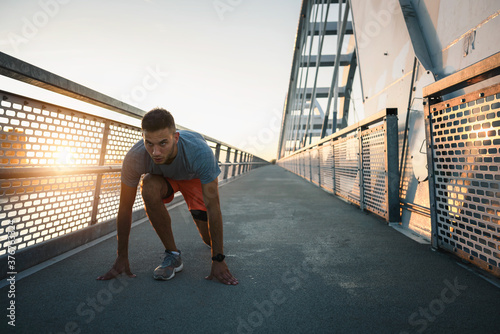 Sports man exercising outdoors in the sunset