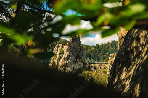 landscape photography of picturesque mountain rock peak in natural foliage unfocused foreground frame wilderness interesting place scenery