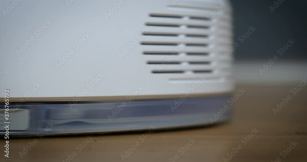 Robotic vacuum cleaner on laminate floor in action. Robotic vacuum cleaner on laminate floor in action.