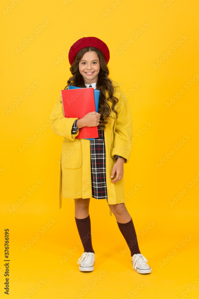 nice smile. little girl with notebook or workbook for lesson. education concept. school and fashion. child in pupil uniform. kid in french beret on yellow background. stylish teen college student nice smile. little girl with notebook or workbook for lesson. education concept. school and fashion. child in pupil uniform. kid in french beret on yellow background. stylish teen college student