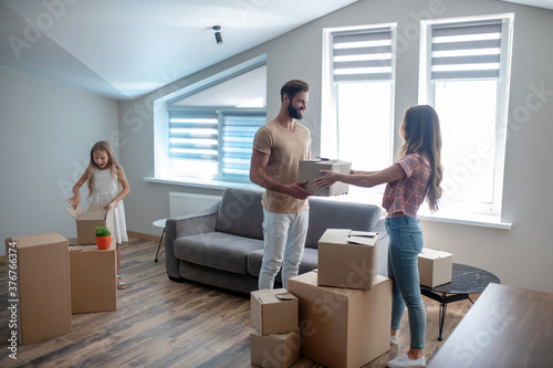 Family unpacking their stuff in a new house