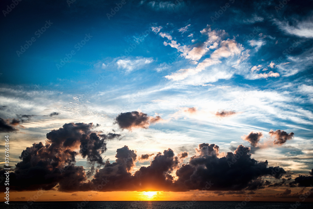 Sun setting over the equator in the Raja Ampat islands of West Papua in the Halmahera sea, West Papua, Indonesia Sun setting over the equator in the Raja Ampat islands of West Papua in the Halmahera sea, West Papua, Indonesia