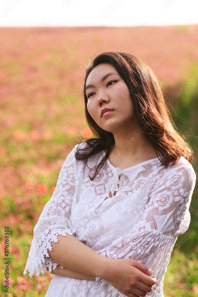 Outdoor Portrait of a beautiful Asian women. Attractive girl in a field at sunset. Outdoor Portrait of a beautiful Asian women. Attractive girl in a field at sunset.
