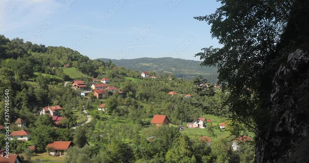 Beautiful background landscape video of a village with houses standing in the woods near the mountains. Beautiful background landscape video of a village with houses standing in the woods near the mountains.