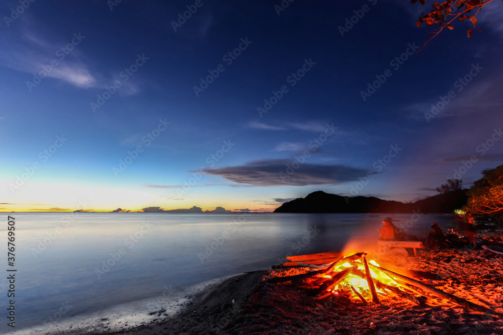 Campfire on the beach on a deserted island in the Raja Ampat islands of West Papua, Indonesia Campfire on the beach on a deserted island in the Raja Ampat islands of West Papua, Indonesia