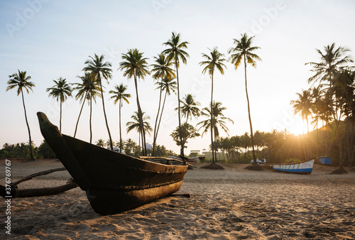 Moored boat, Agonda beach at sunset, Goa, India photo
