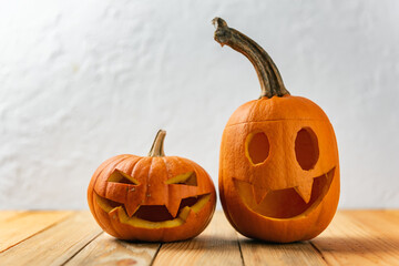 Two pumpkins on wooden table. Halloween and autumn food background