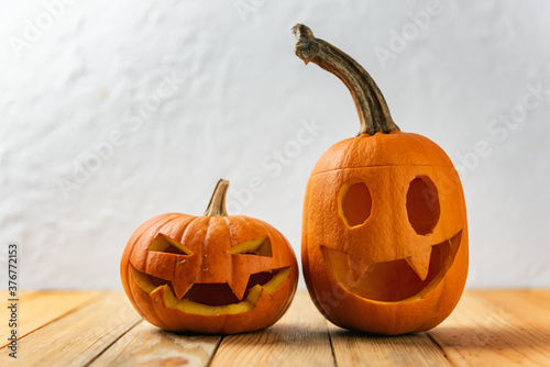 Two pumpkins on wooden table. Halloween and autumn food background