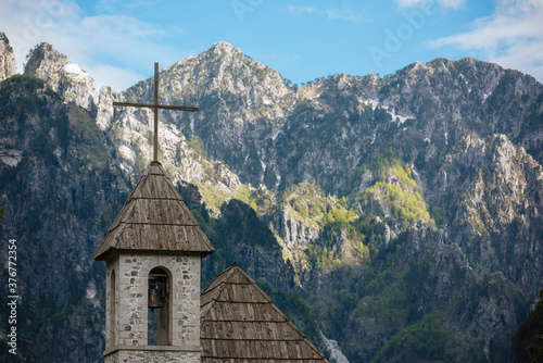 Village church bell tower and Accursed Mountains, Theth, Tirana, Albania photo