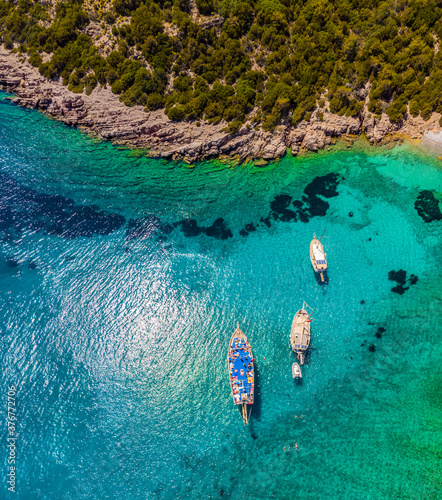 Fototapeta Naklejka Na Ścianę i Meble -  Drone view to the Aegean sea with boats and its shore in famous tourist city Bodrum in Turkey