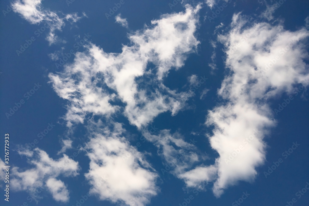 Dark blue sky with white clouds. Background. Dark blue sky with white clouds. Background.